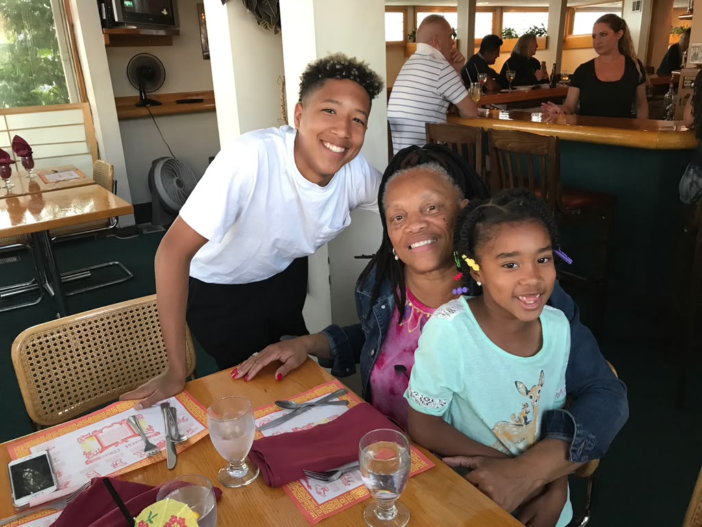 Debra sharing a multigenerational family moment around a table