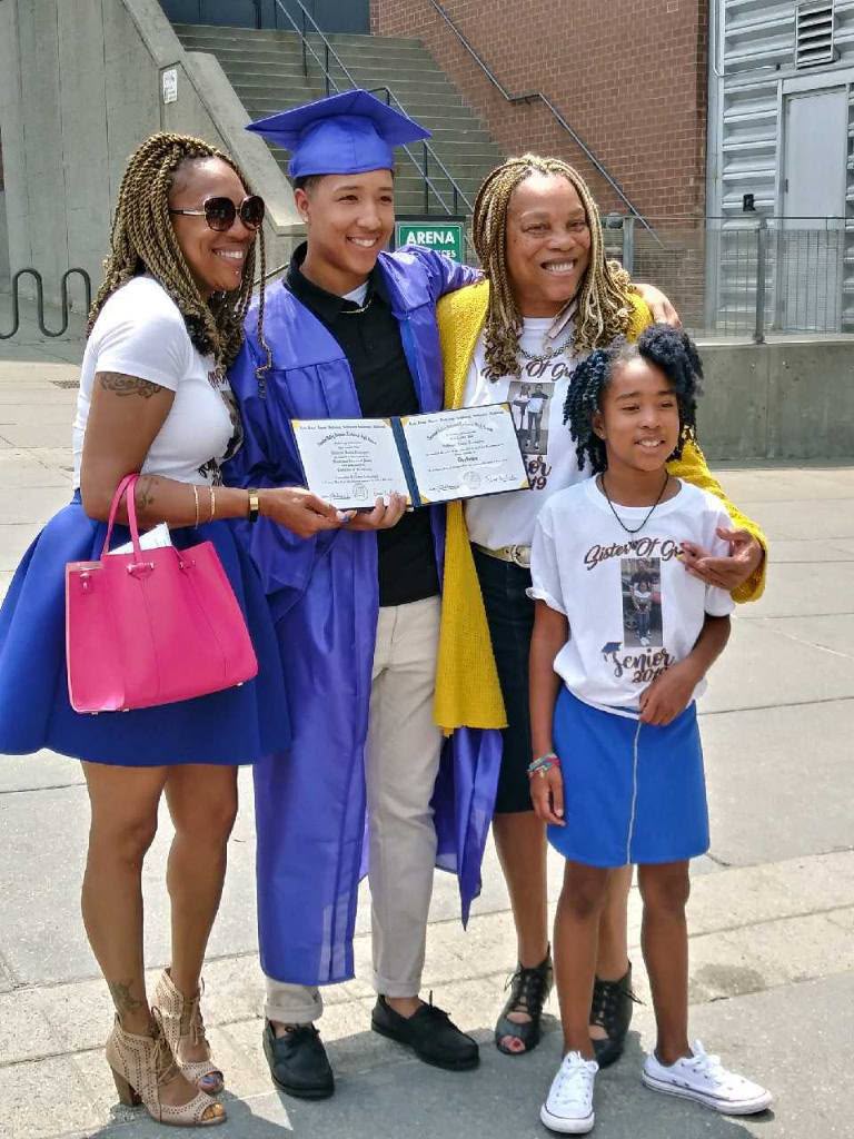 Debra celebrating with family at a graduation ceremony