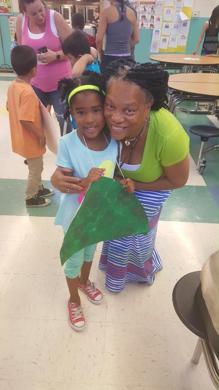 Debra sharing a warm moment with a young student at a school event